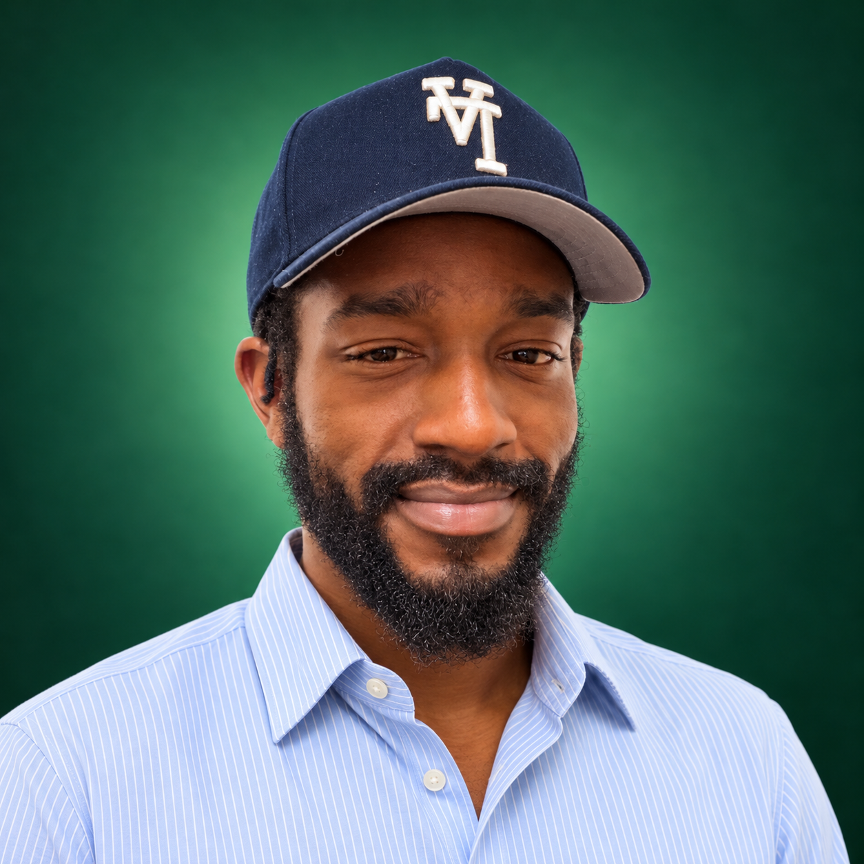 Lewie Allen wearing a navy cap against an emerald studio background